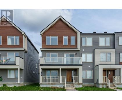 A row of townhouses with balconies and front doors.