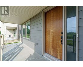 A wooden door with a glass window on the right side.