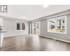 A spacious room with a large window overlooking a building.