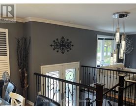 A dining room with a table and chairs.