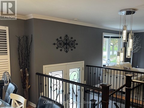 A dining room with a table and chairs.