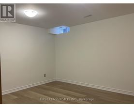 A room with a wooden floor and a light on the ceiling.