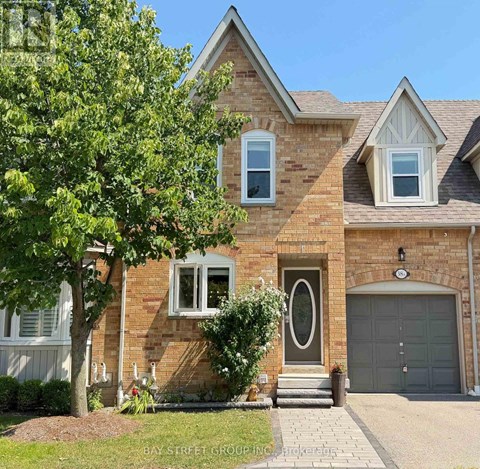A brick house with a large front door and a garage door.