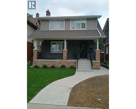 A house with a grey roof and a black front door.
