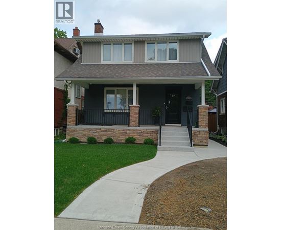 A house with a grey roof and a black front door.