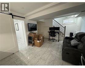 A living room with a couch, chair, and a television.