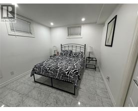 A bedroom with a zebra print bedspread and a small table.