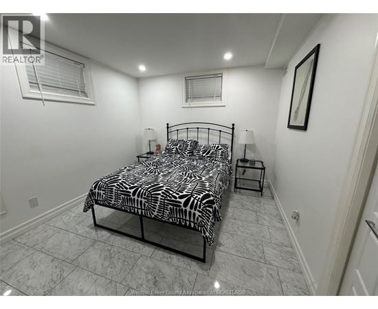 A bedroom with a zebra print bedspread and a small table.