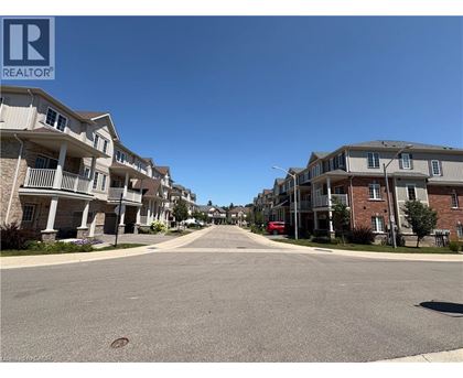 A street view of a residential area with apartment buildings on both sides.