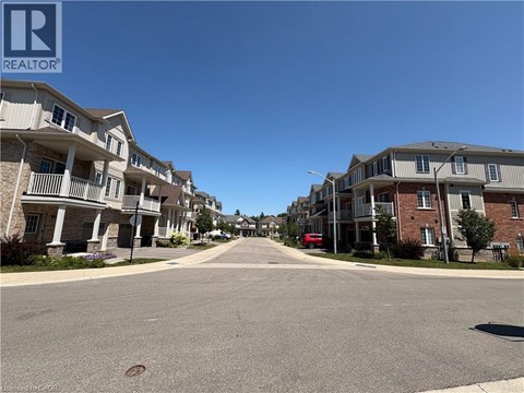 A street view of a residential area with apartment buildings on both sides.