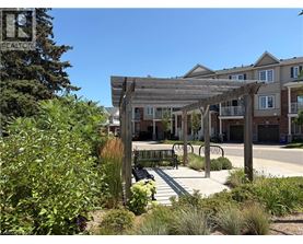 A realtor sign is in the foreground of a residential area.