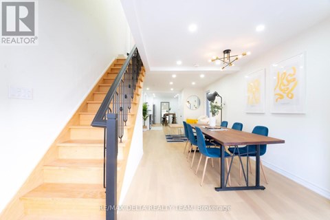 A dining room with a long table and chairs is shown.