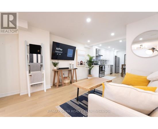 A modern living room with a white sofa and a wooden coffee table.