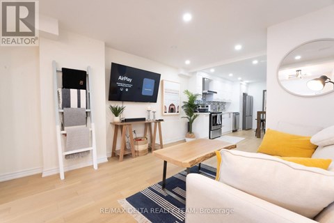A modern living room with a white sofa and a wooden coffee table.
