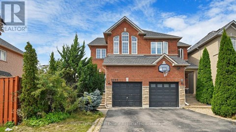 A large brick house with a basketball hoop on the front.
