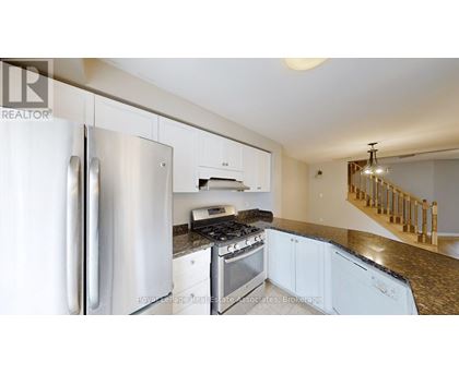 A kitchen with a stainless steel refrigerator and a stove top oven.