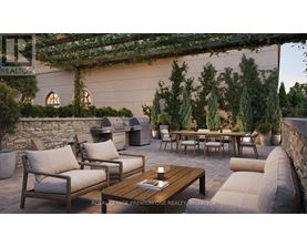 A patio with a table, chairs, and a stone wall.