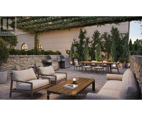 A patio with a table, chairs, and a stone wall.