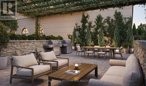 A patio with a table, chairs, and a stone wall.