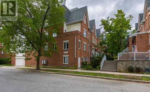 A street view of a residential area with houses and trees.