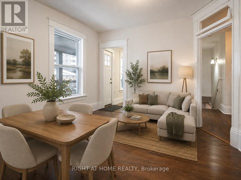 A well-lit living room with a dining table and chairs.