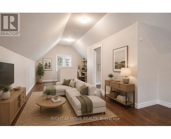A well-lit living room with a couch, coffee table, and a television.