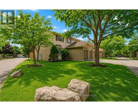 A house with a lawn and trees in front of it.