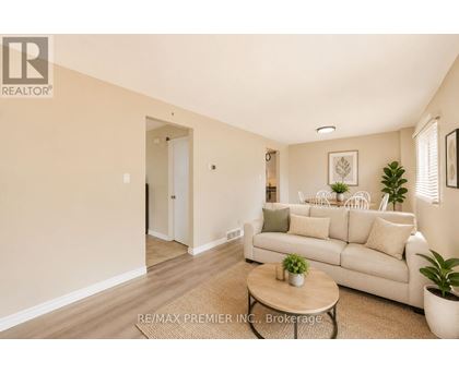 A living room with a white couch and a coffee table.