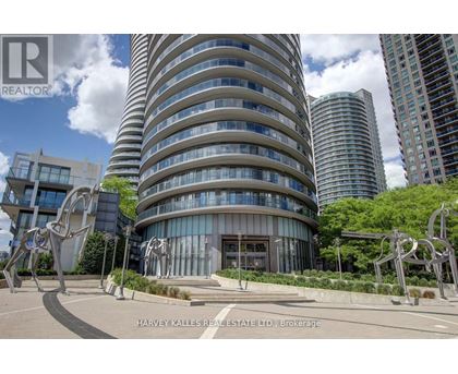 A modern building with a curved glass facade is the focal point of the image.