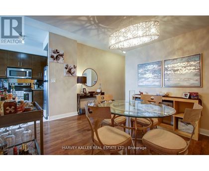 A dining room with a glass table and chairs.