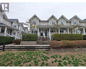 A large house with a green lawn in front.