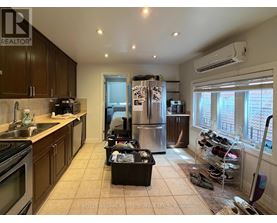 A kitchen with a refrigerator, sink, and oven.