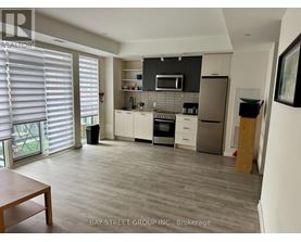 A kitchen with a dining table and a refrigerator.