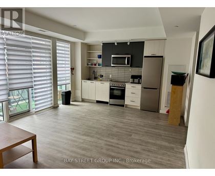 A kitchen with a dining table and a refrigerator.
