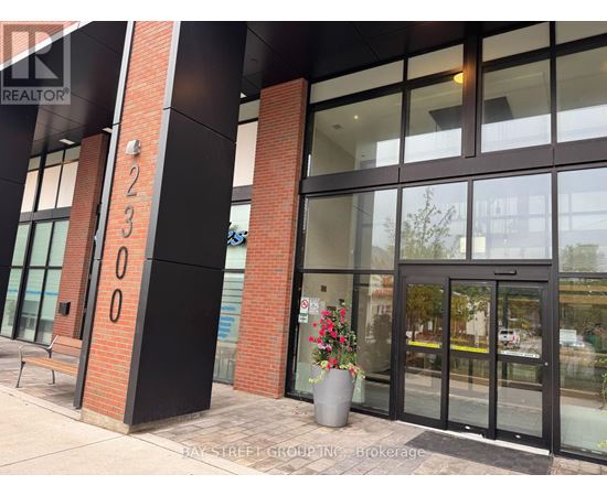 The entrance to a building with the number 12300 on the pillar.