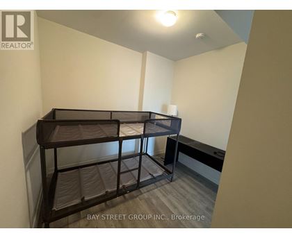 A bedroom with a bunk bed and a desk.