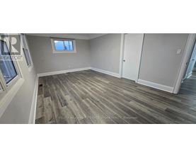 A room with wood flooring and a window.
