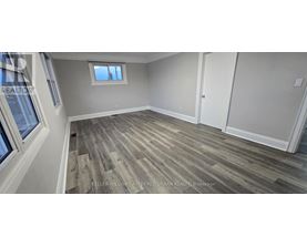 A room with wood flooring and a window.