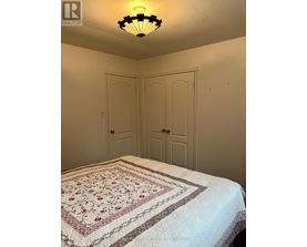 A bedroom with a bed and two doors.