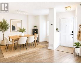 A dining room with a table set for four.