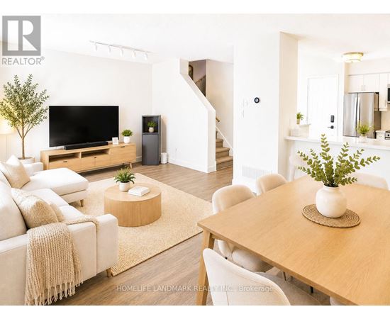 A living room with a couch, a television, and a dining table.