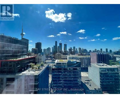 A cityscape with a clear sky and a building under construction.