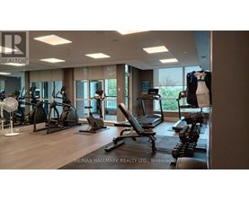 A gym with a variety of equipment including treadmills, weights, and exercise machines.