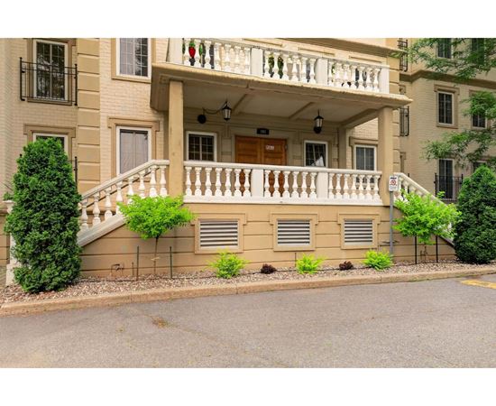 A building with a balcony and a staircase leading to the balcony.