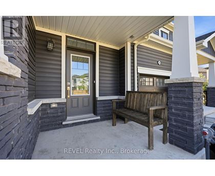 A house with a grey front porch and a wooden bench.