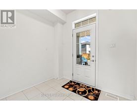 A white door with a glass window is in a room with white walls.