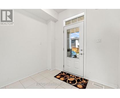 A white door with a glass window is in a room with white walls.
