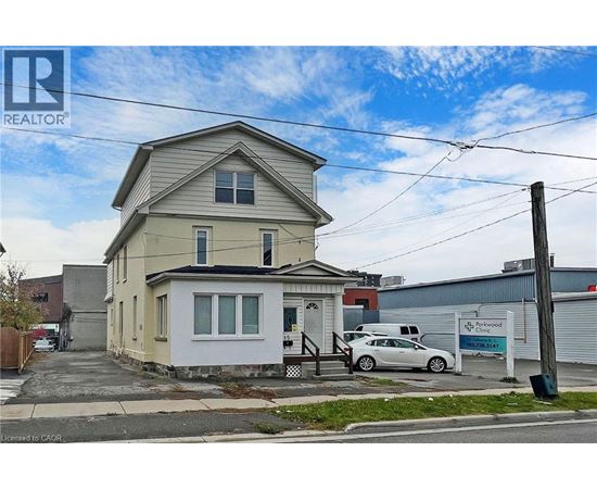 A two-story house with a car parked in front.