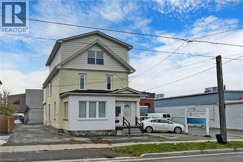 A two-story house with a car parked in front.