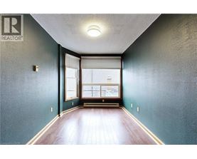 A hallway with a window and a wooden floor.
